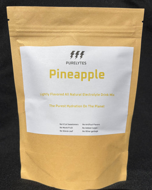 Pineapple-flavored electrolyte drink mix package with 'Purelytes' branding on a black background